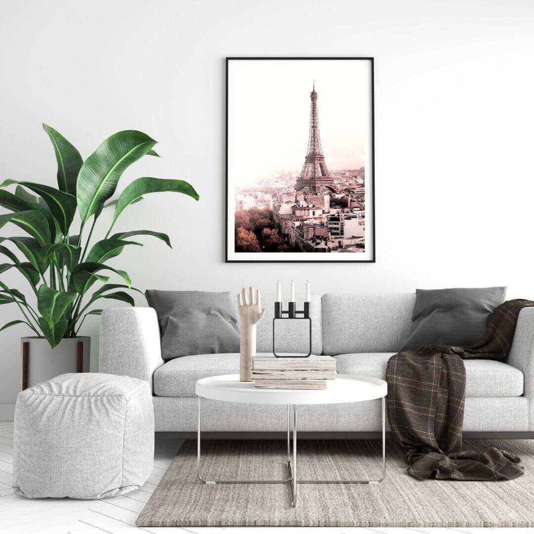 A wall art photo print of the Eiffel Tower in Paris with a black frame on a wall above a sofa by Beautiful HomeDecor