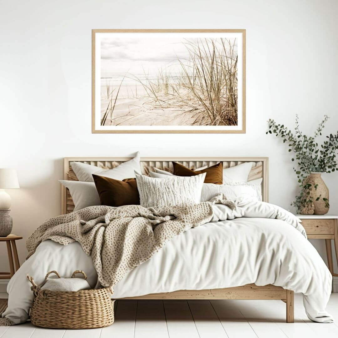 A wall art photo print of a grassy beach shore with a timber frame to decorate your bedroom walls