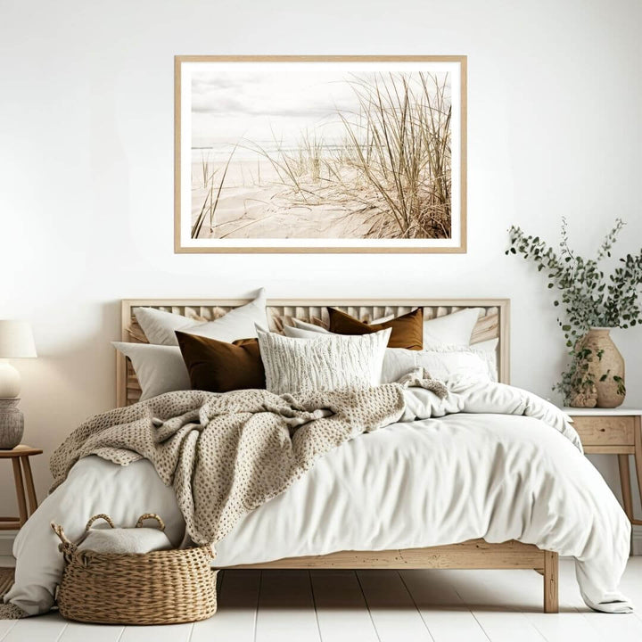 A wall art photo print of a grassy beach shore with a timber frame to decorate your bedroom walls