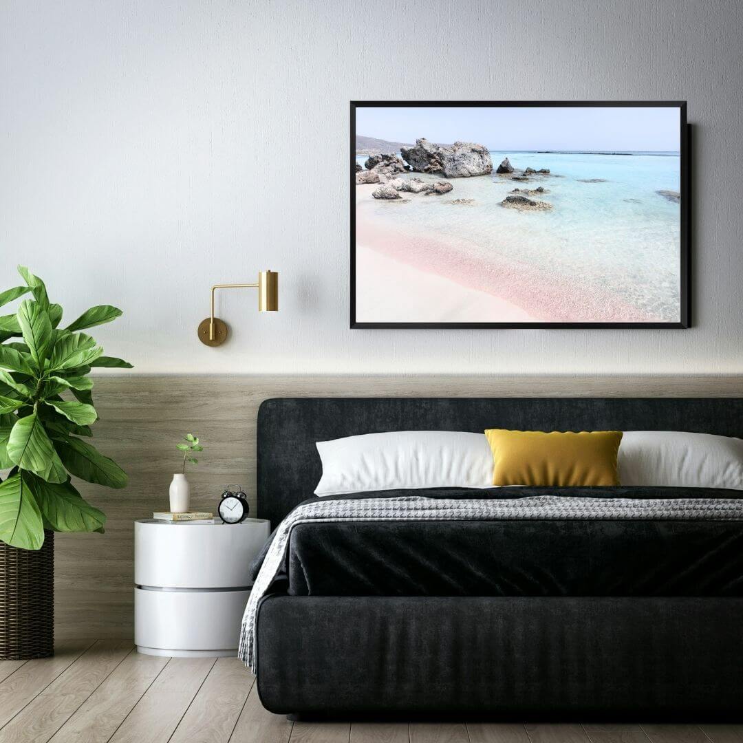 A coastal wall art photo print of a pink beach in Greece with a black frame to decorate your bedroom by Beautiful Home Decor