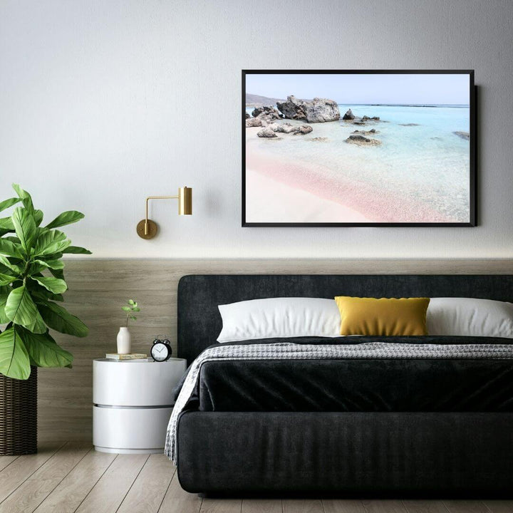 A coastal wall art photo print of a pink beach in Greece with a black frame to decorate your bedroom by Beautiful Home Decor