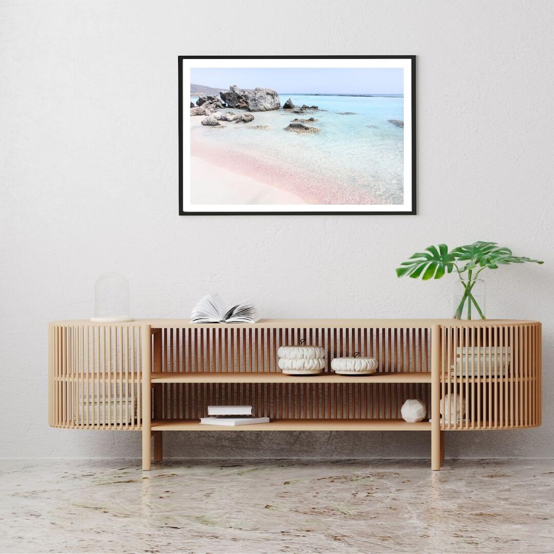 A coastal wall art photo print of a pink beach in Greece with a black frame or unframed to decorate a wall above your console table