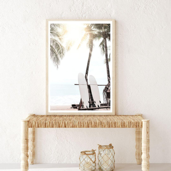 A coastal hallway wall art of two white surfboards on a surfer beach in Hawaii under the palm trees on a surfer beach in Hawaii view.