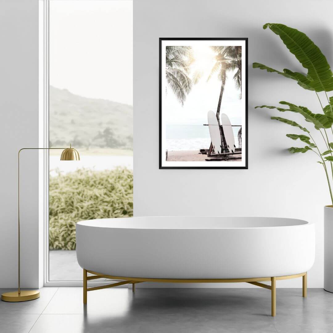 A wall art print in the bathroom of two surf boards under the palm trees on a surfer beach in Hawaii in a bathroom