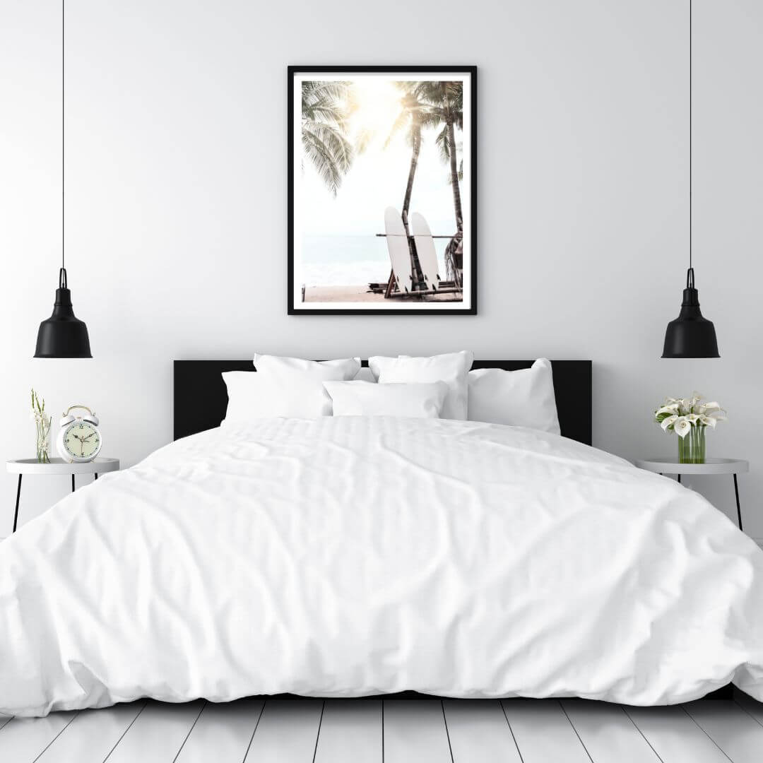 A photographic artwork of two white surf boards under the palm trees on a surfer beach in Hawaii on a bedroom wall