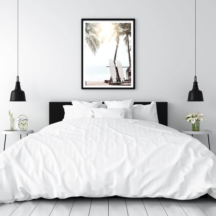 A photographic artwork of two white surf boards under the palm trees on a surfer beach in Hawaii on a bedroom wall