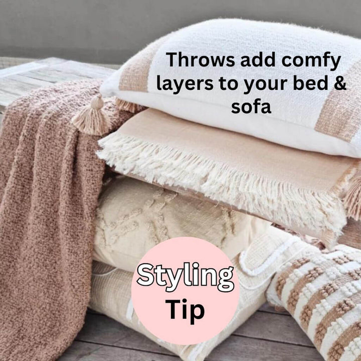 A soft and comfy Jade throw in warm taupe with a boucle pattern and tassels, measuring 130cm x 160cm, to style your bed or sofa.