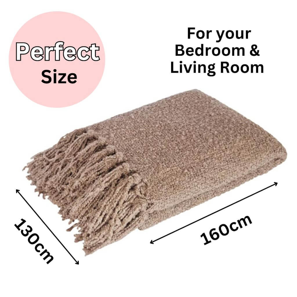 A beautiful Jade throw in warm taupe with a boucle pattern and tassels, measuring 130cm x 160cm, perfect to style your bed or sofa.
