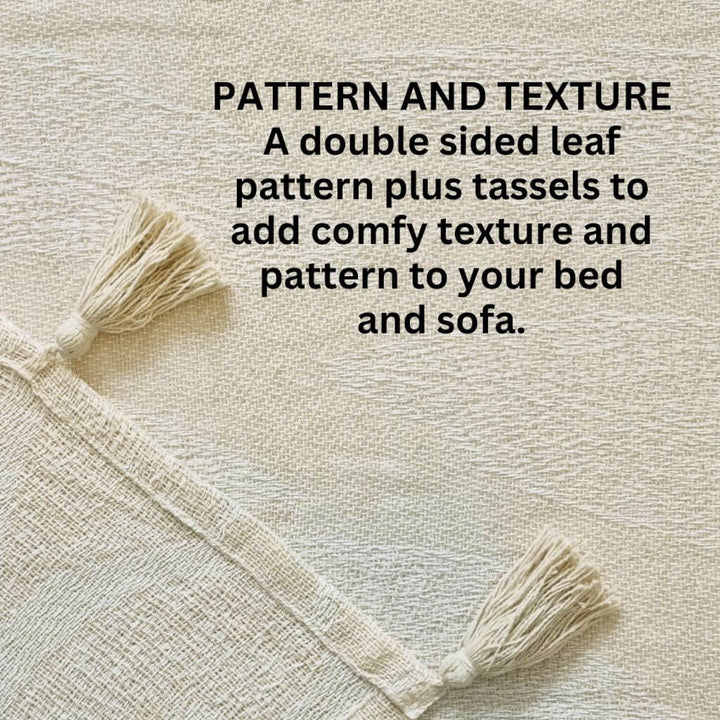 The Kye Cream & Ivory Cotton Throw with a leaf pattern on both sides and tassels, measures 130cmx 160cm to style your bed or sofa.