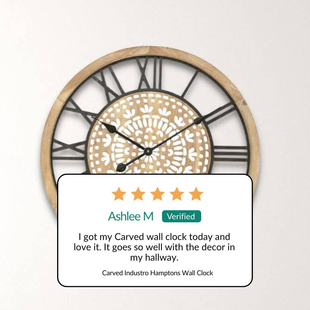 Carved wall clock with a five-star review from Ashlee M on a light background