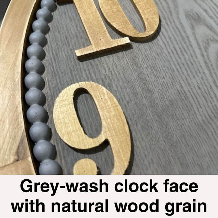 Close-up of a clock face with grey-wash and natural wood grain design.