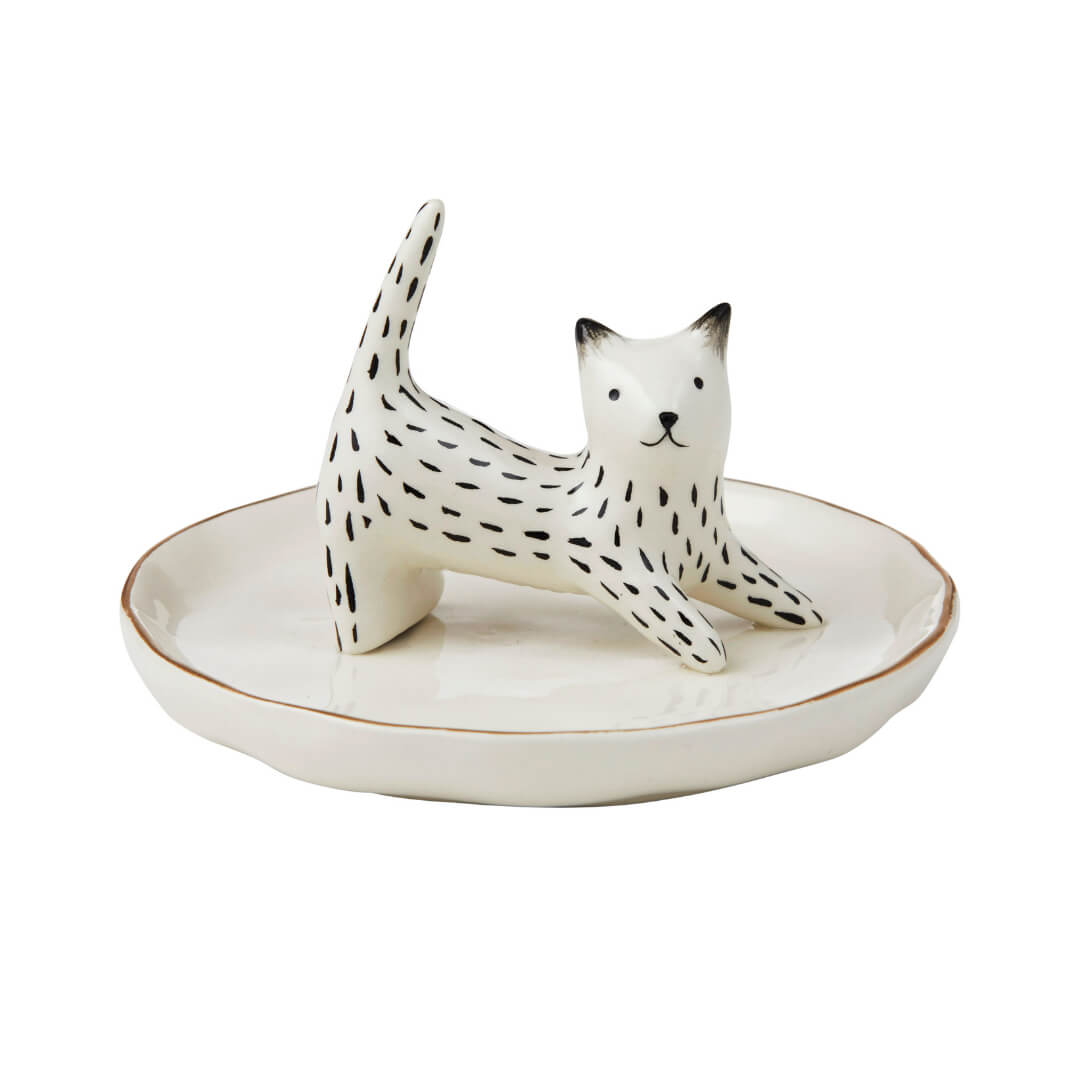 Ceramic cat figurine jewellery holder on a white plate with a white background