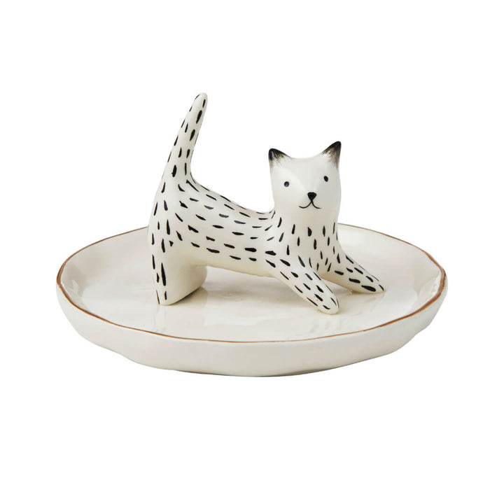 Ceramic cat figurine jewellery holder on a white plate with a white background