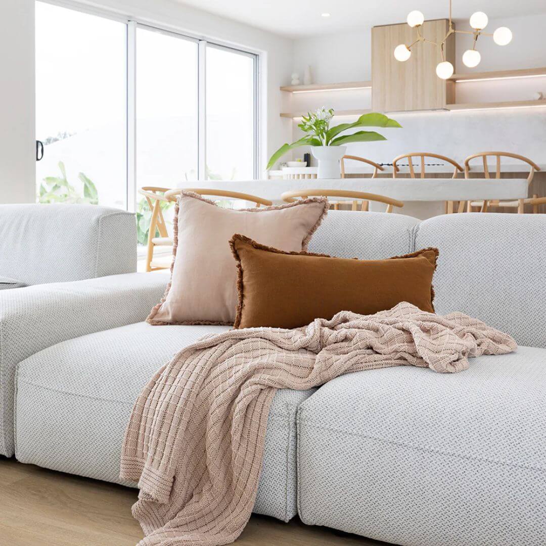 Soft blush cotton throw draped over a  sofa with matching linen cushions -Beautiful Home Decor
