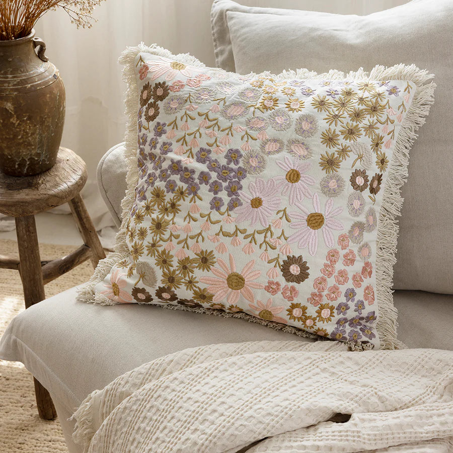 The 50cm Millie Square cushion with a floral embroidered pattern in pink, lilac, purple, brown and cream to style your sofa