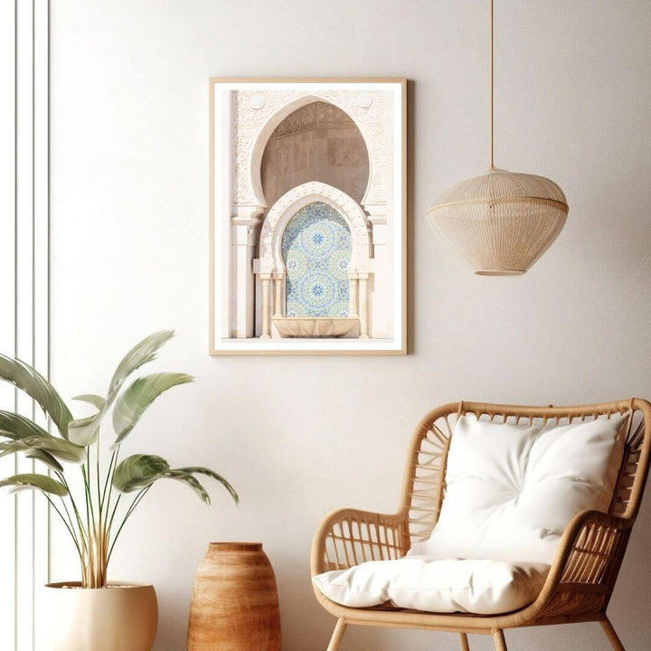 a Moroccan Temple Arch Wall Art Photo Print with a frame on a wall next to a living room accent chair