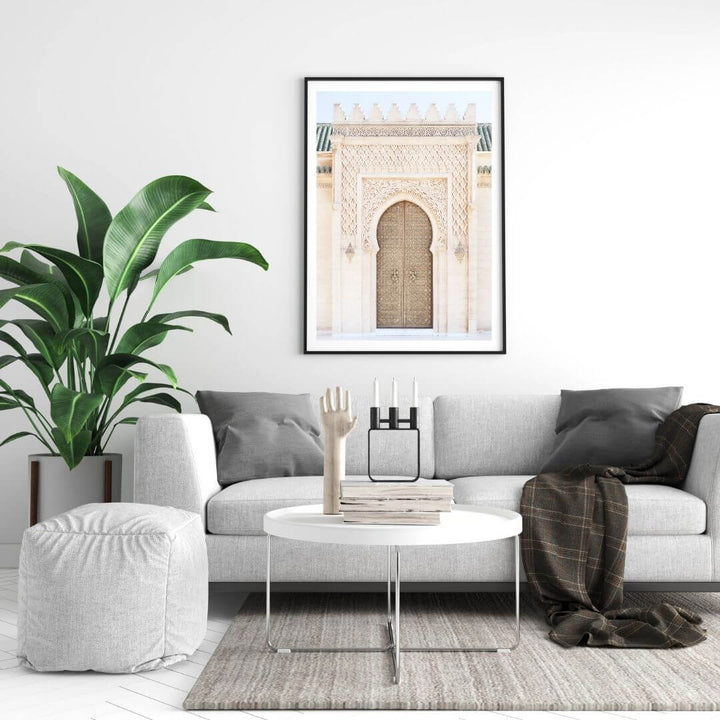 A wall art photo print of a Moroccan Temple Door with a black frame, white border on wall above living room sofa