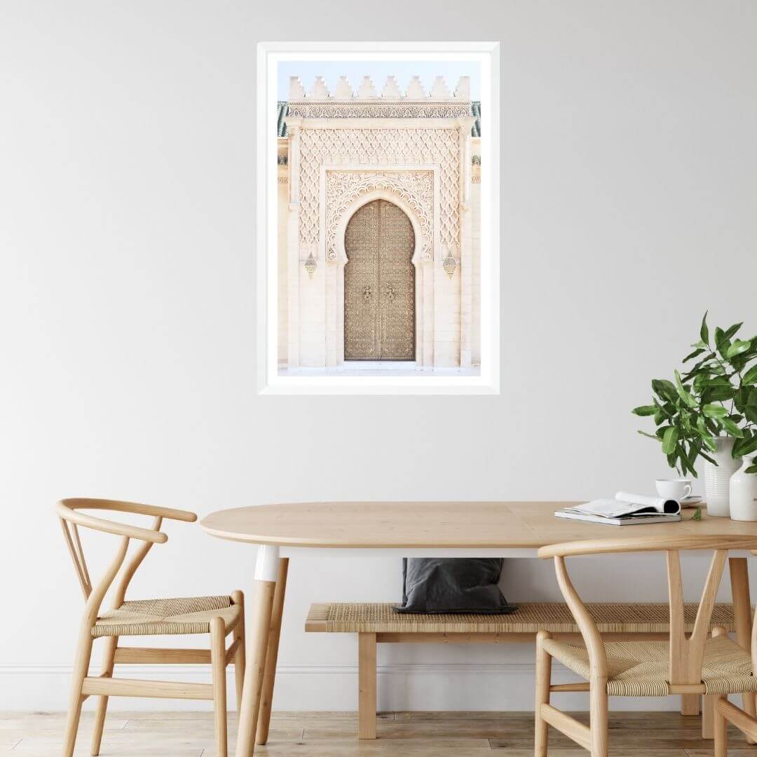 A wall art photo print of a Moroccan Temple Door with a white frame on dining room wall by Beautiful Home Decor