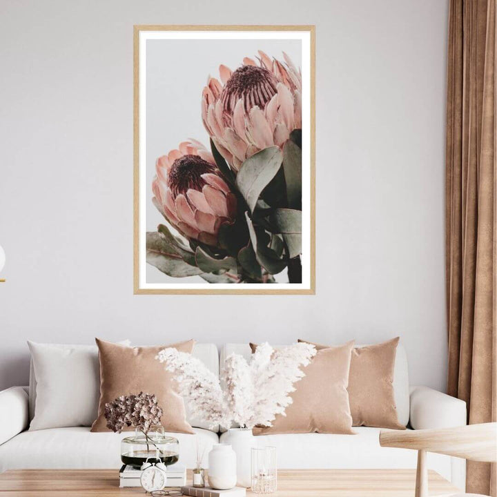 The wall art photo print of a peach protea floral b with a timber frame for the wall in your living room