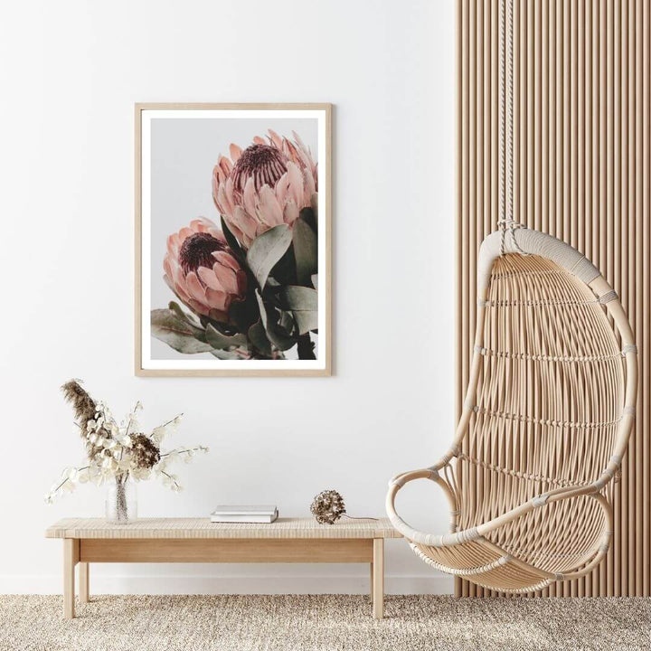 The wall art photo print of a peach protea floral b with a timber frame to style a wall in living room