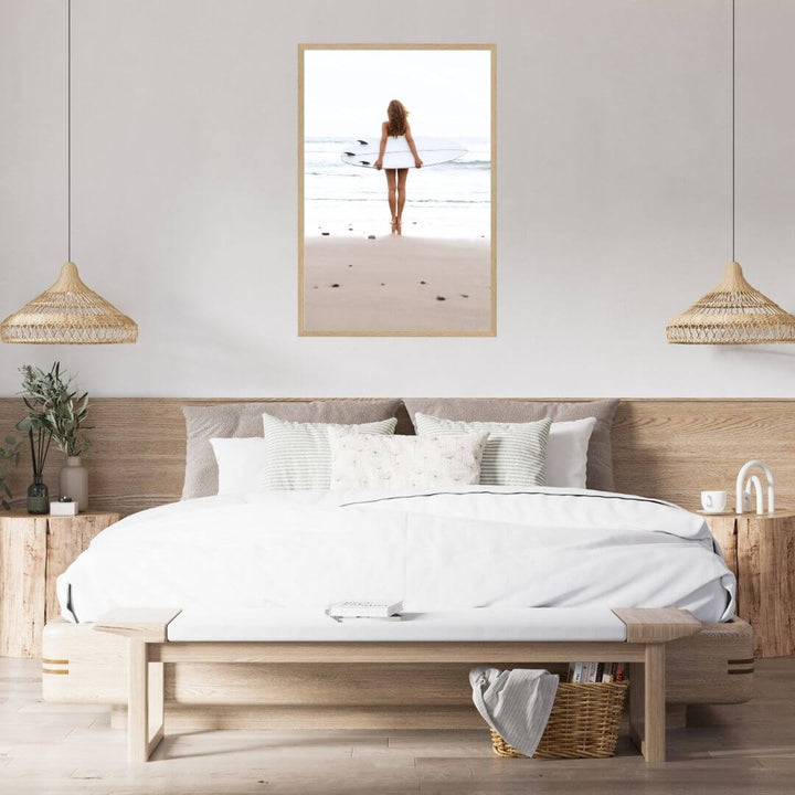 A wall art photo print of the girl with the surfboard with a timber frame to decorate your bedroom walls
