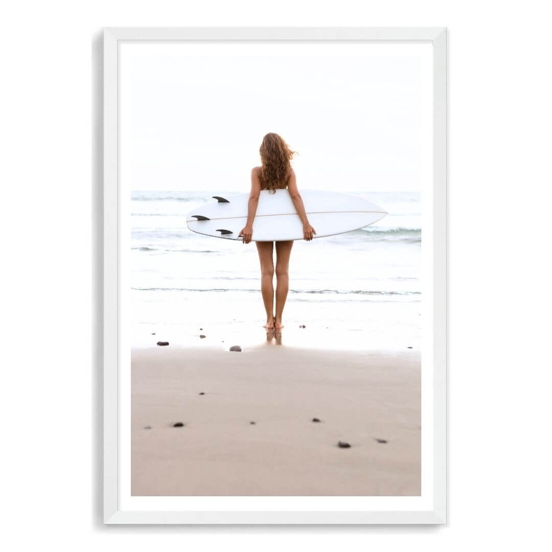 A wall art photo print of the girl with the surfboard with a white frame, white border by Beautiful Home Decor