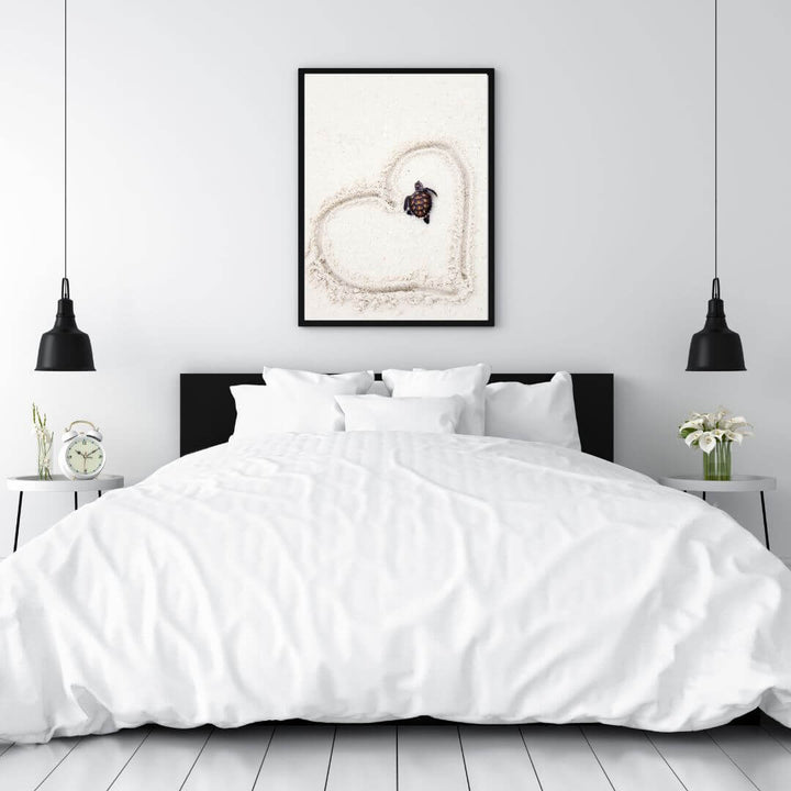 A wall art photo print of a turtle on the beach with a black frame or unframed to decorate a wall in your bedroom