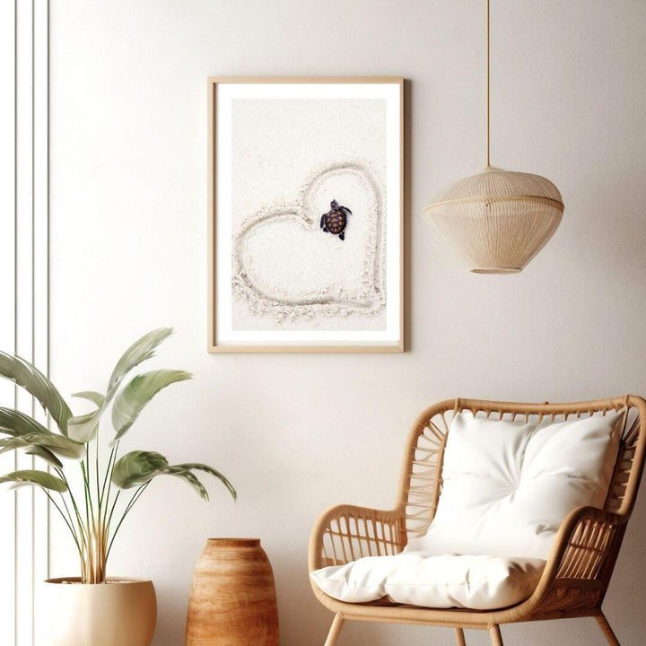 A coastal wall art photo print of a turtle on the beach with a heart in a timber frame for the living room by Beautiful Home Decor