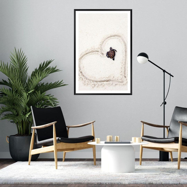 A coastal wall art photo print of a turtle on the beach with a black frame or unframed for the wall in living room