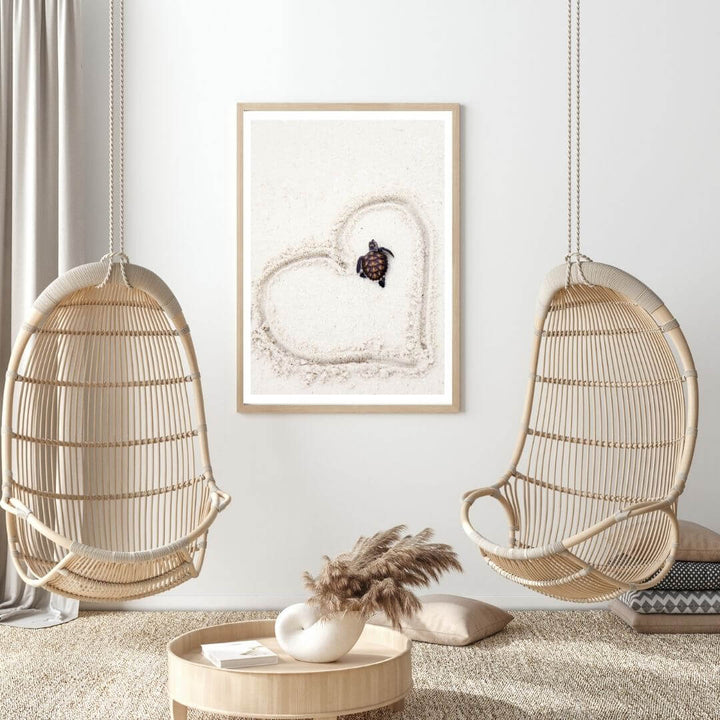 A coastal wall art photo print of a heart around a turtle on the beach with a timber frame or unframed for your living room empty walls