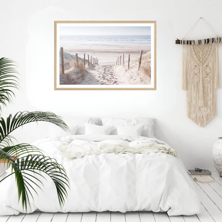 A wall art photo print of a walk on the beach with a timber frame to style a coastal Australian bedroom