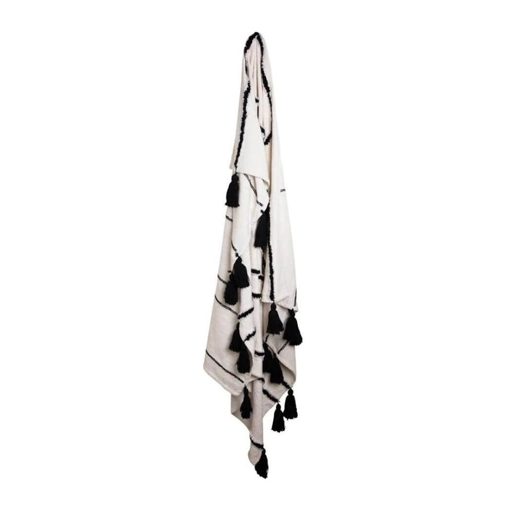 The Black and Ivory White Waverley Throw with tassels and a u shaped pattern, measures 130cm x 160cm, the perfect throw to style your bed or sofa.