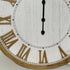 The white clock face on a large 68cm white hamptons roman numerical wall clock with raised timber numerals.