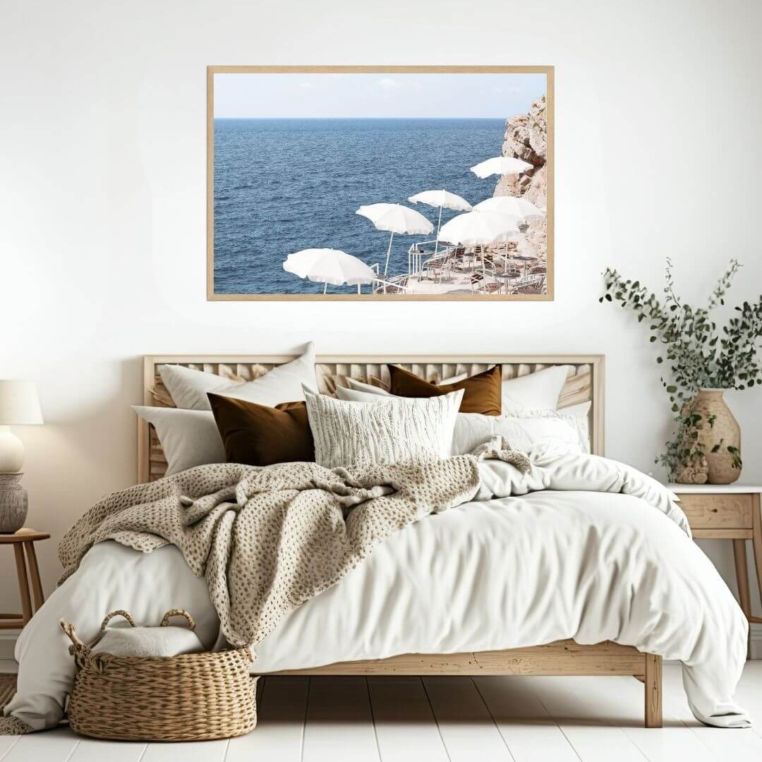 A coastal wall art photo print of white umbrellas on an Amalfi Coast Beach Italy with a timber frame to style a coastal Australian bedroom