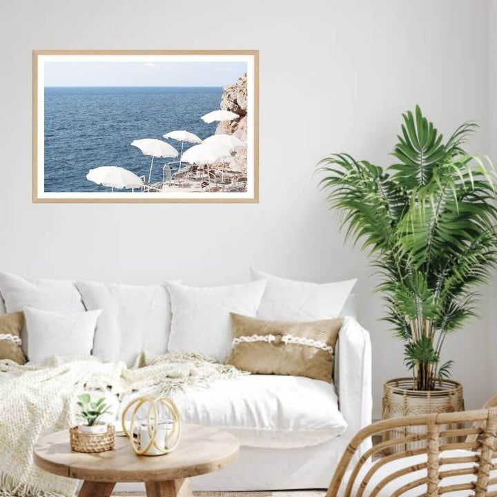 A coastal wall art photo print of white umbrellas on an Amalfi Coast Beach Italy with a timber frame or unframed for your living room empty walls