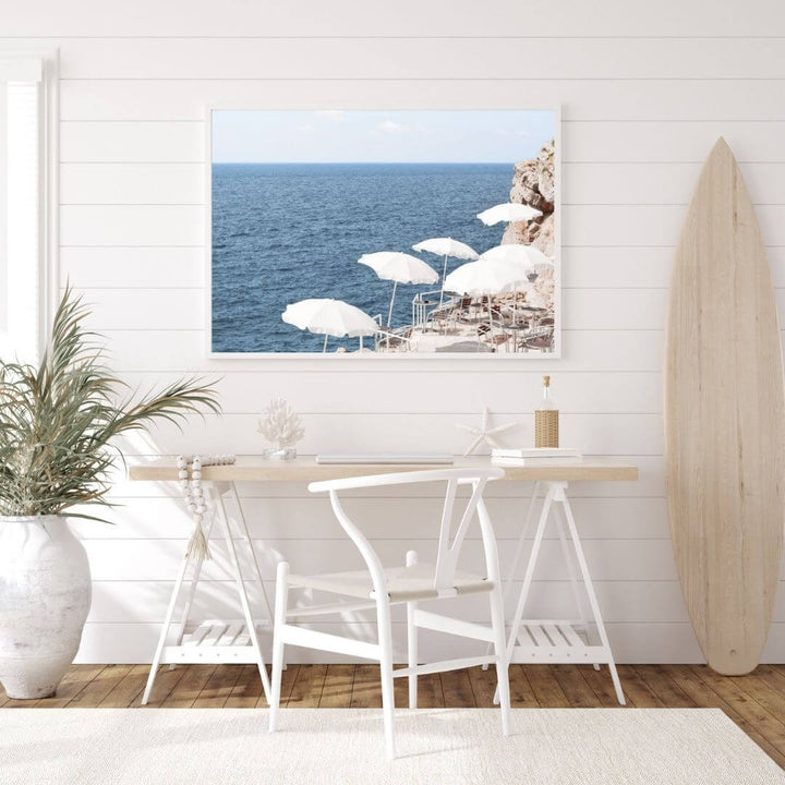A coastal wall art photo print of white umbrellas on an Amalfi Coast Beach Italy with a white frame or unframed to decorate an empty wall