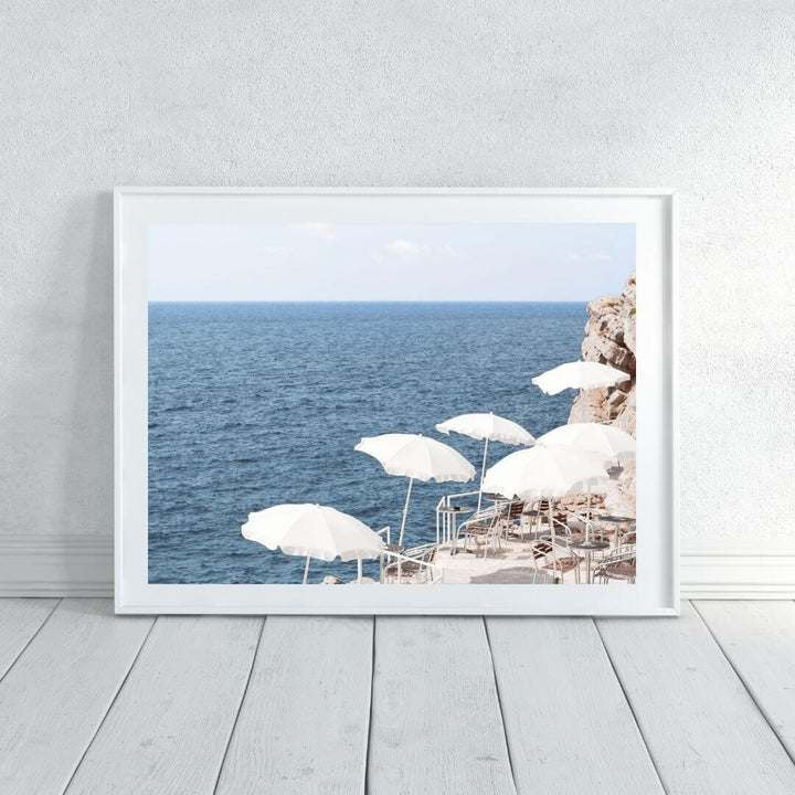 A coastal wall art photo print of white umbrellas on an Amalfi Coast Beach Italy with a black frame or unframed shop online at Beautiful Home Decor with free shipping