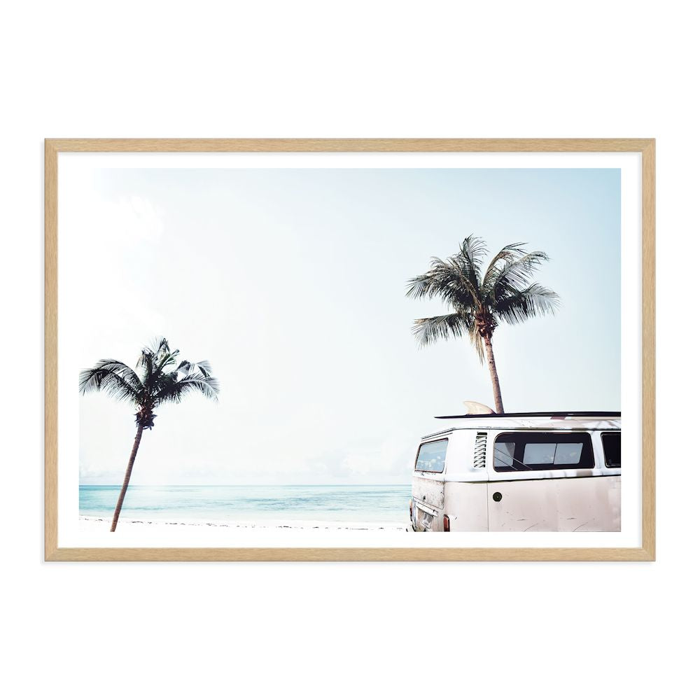 A wall art print of an iconic blue Kombi van at the beach with palm trees, available in canvas or photo print.
