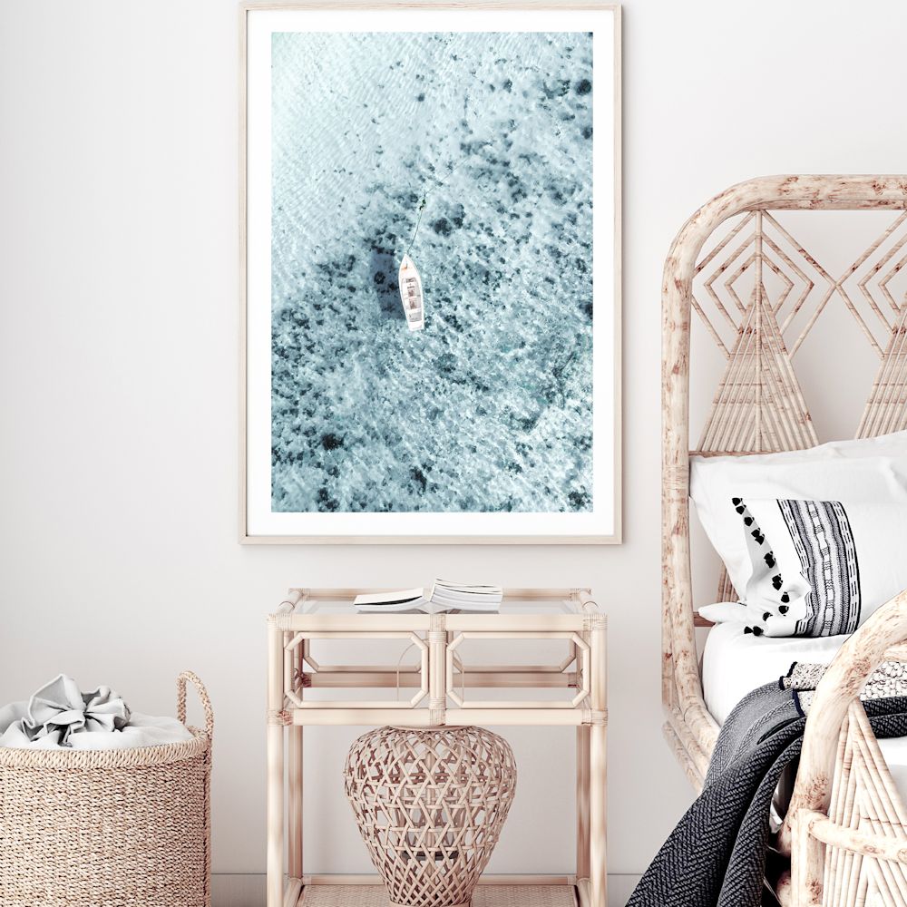 This stretched canvas Hamptons artwork print taken off the Amalfi Caost in Italy features a white boat on the clear blue ocean waters.