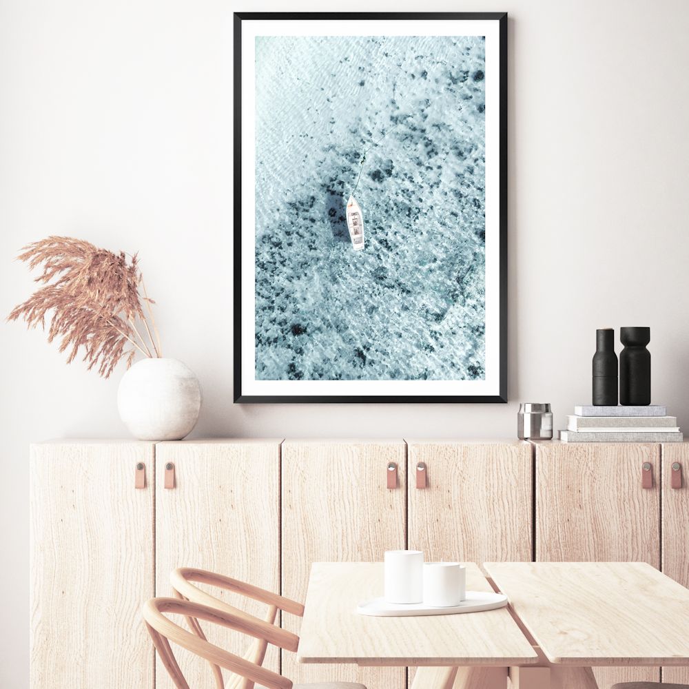 A Hamptons artwork print featuring a white boat on the clear blue ocean waters, taken off the Italian Amalfi Coast. 