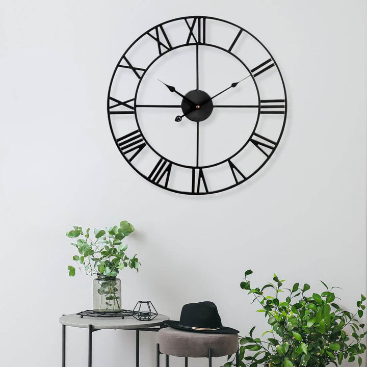 Black metal wall clock styled in contemporary Australian home