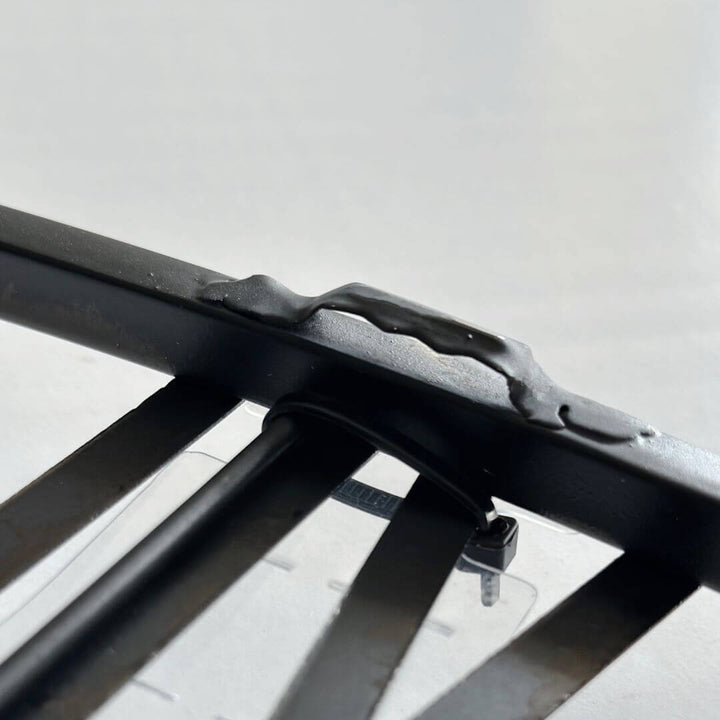Back view showing easy-to-hang hook on black metal wall clock