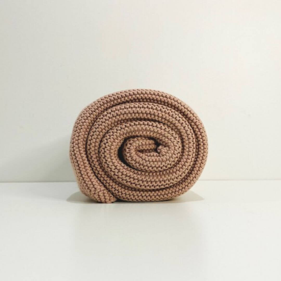 A gorgeous lusciously soft Cable Knitted Baby Blanket made by Mini and Me, in beautiful Blush pink to keep your baby warm.