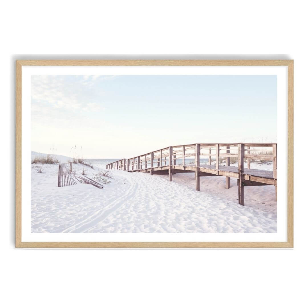 A wall art photo print of a beachside boardwalk with a timber frame, white border by Beautiful Home Decor