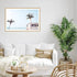 A coastal wall art photo print of a beige beachside kombi van with a timber frame for the wall in your living room