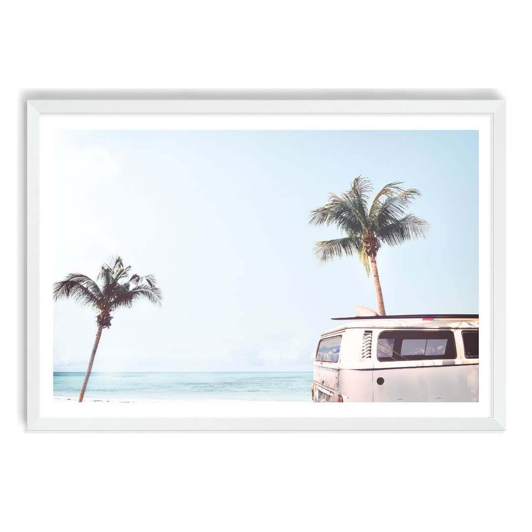 A wall art photo print of a blue beachside kombi van with a white frame, white border by Beautiful Home Decor