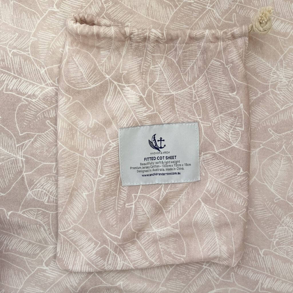 A super soft and breathable Jersey Cotton Baby Cot Sheet in a beautiful Palm Pink design. 