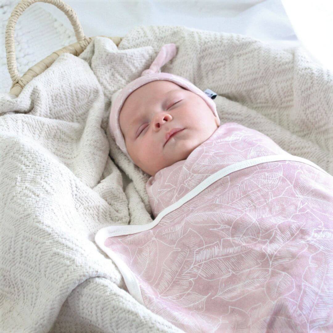 Keep your baby warm with a gorgeous Beannie and Swaddle wrap in Pink Palm, designed by Anchor and Arrow.
