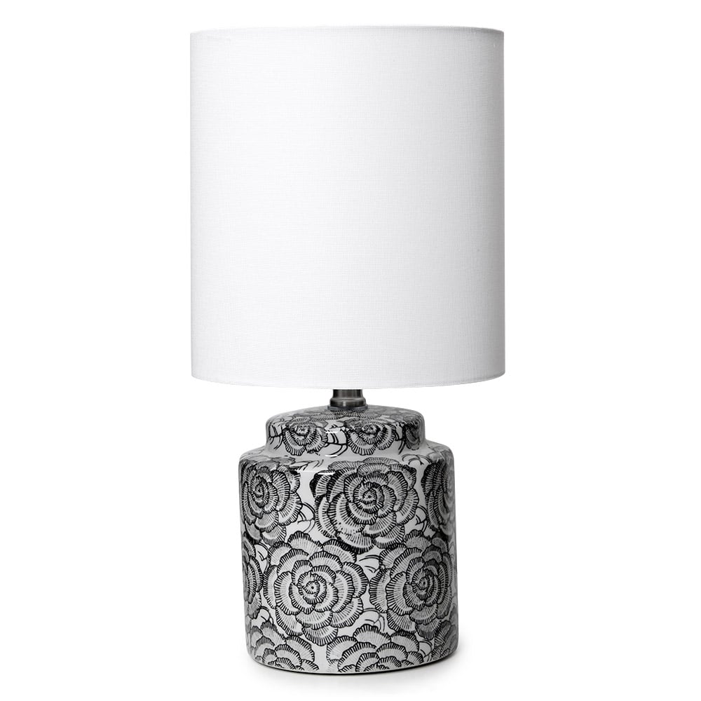The Camelia Table Lamp has a black and white ceramic base with a floral design and white fabric shade, Suits contemporary, mid-century or industrial interior design styles.