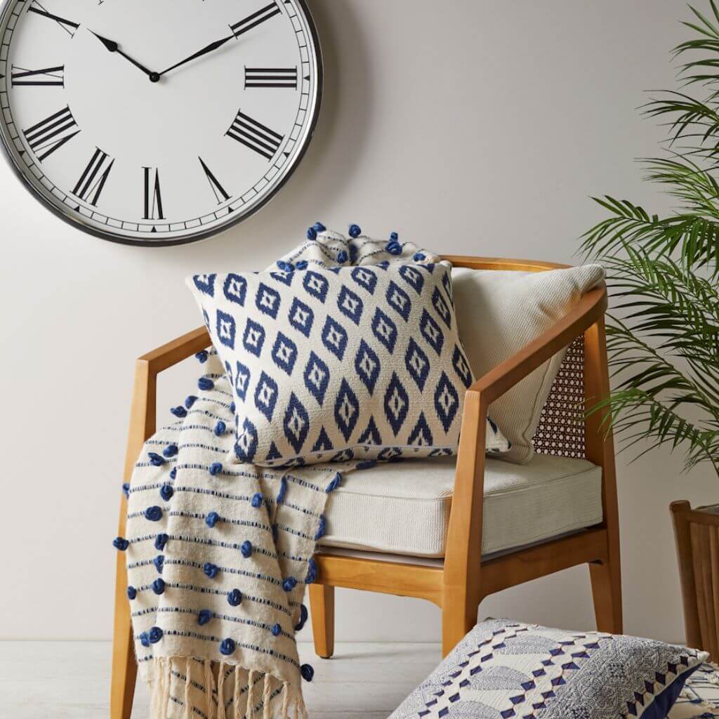 The darj blue and white ikat cushion with a geometric shape perfect to style your Hamptons Coastal Home living room sofa or bedroom